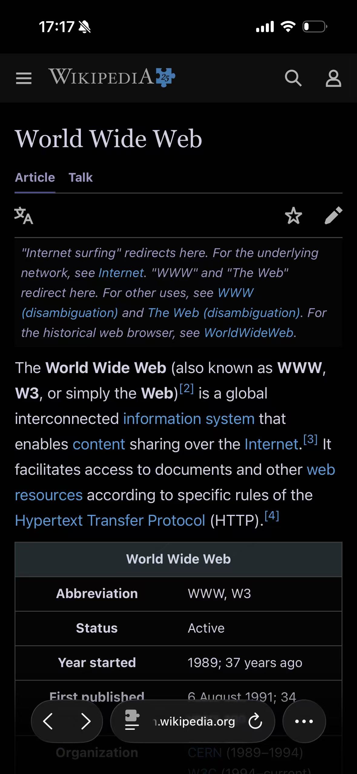 The same Wikipedia article adapted with the Pure Black theme in Safari on iPhone